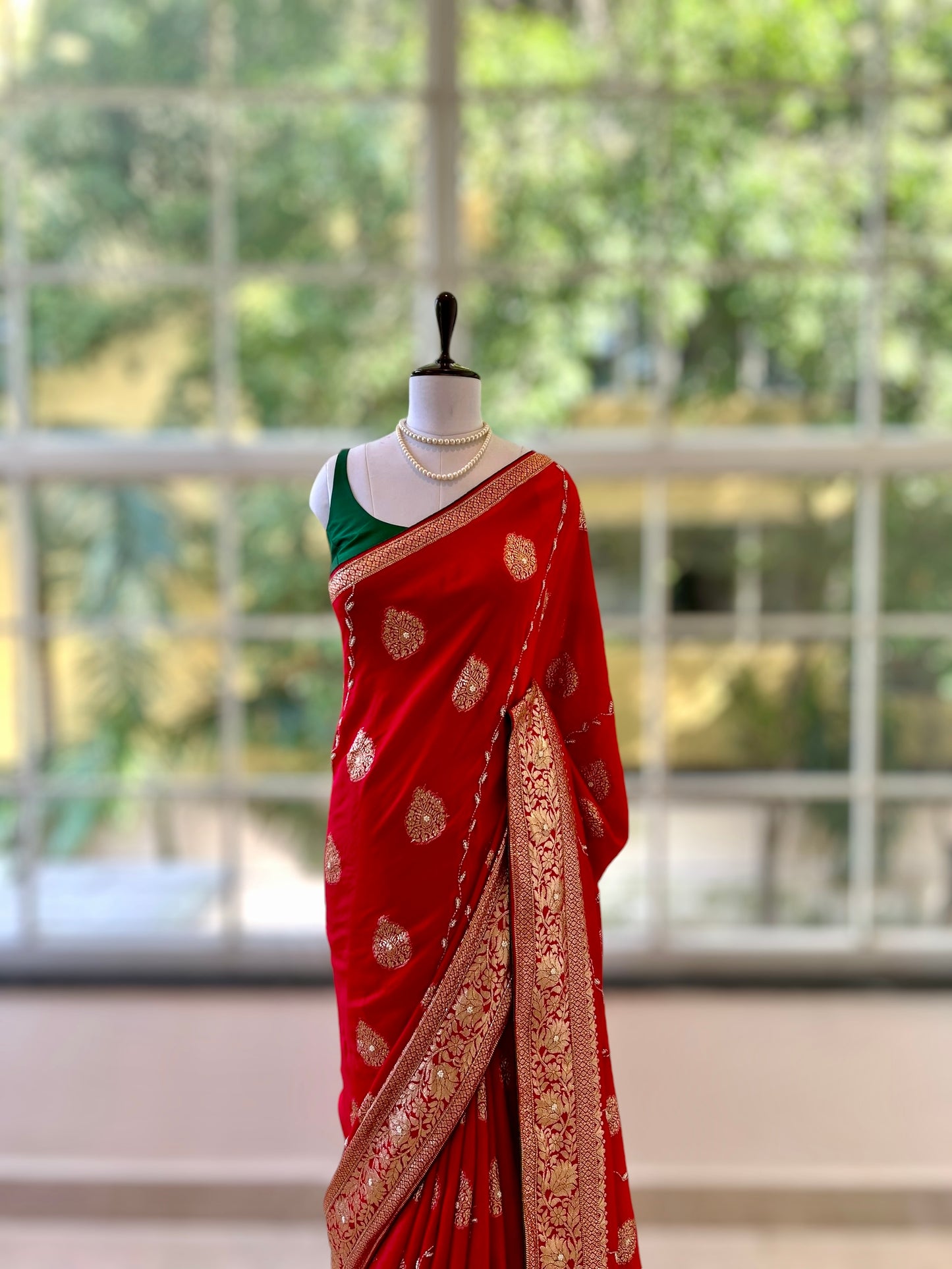 Red pearls embellished saree